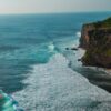 Breathtaking view of towering coastal cliffs with waves crashing in Bali, Indonesia.