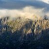 Majestic Lofoten mountain landscape draped in dramatic clouds at sunset.