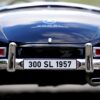 Detailed rear view of a vintage 300 SL 1957 toy car highlighting the emblem and chrome details.