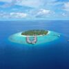 Stunning aerial view of island resort with turquoise waters, Maldives.