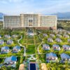 A breathtaking aerial shot of a luxury resort featuring villas, palm trees, and scenic landscapes.