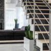 Sleek modern living room featuring a contemporary staircase and elegant decor.