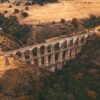 Aerial view of an ancient aqueduct in a picturesque Mexican landscape during autumn.