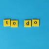 Yellow letter tiles spelling 'to do' against a vibrant blue background for organizational themes.